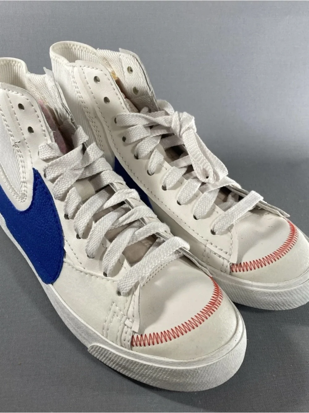 Nike Kids White High-Top Sneakers with Blue Swoosh and Red Stitching